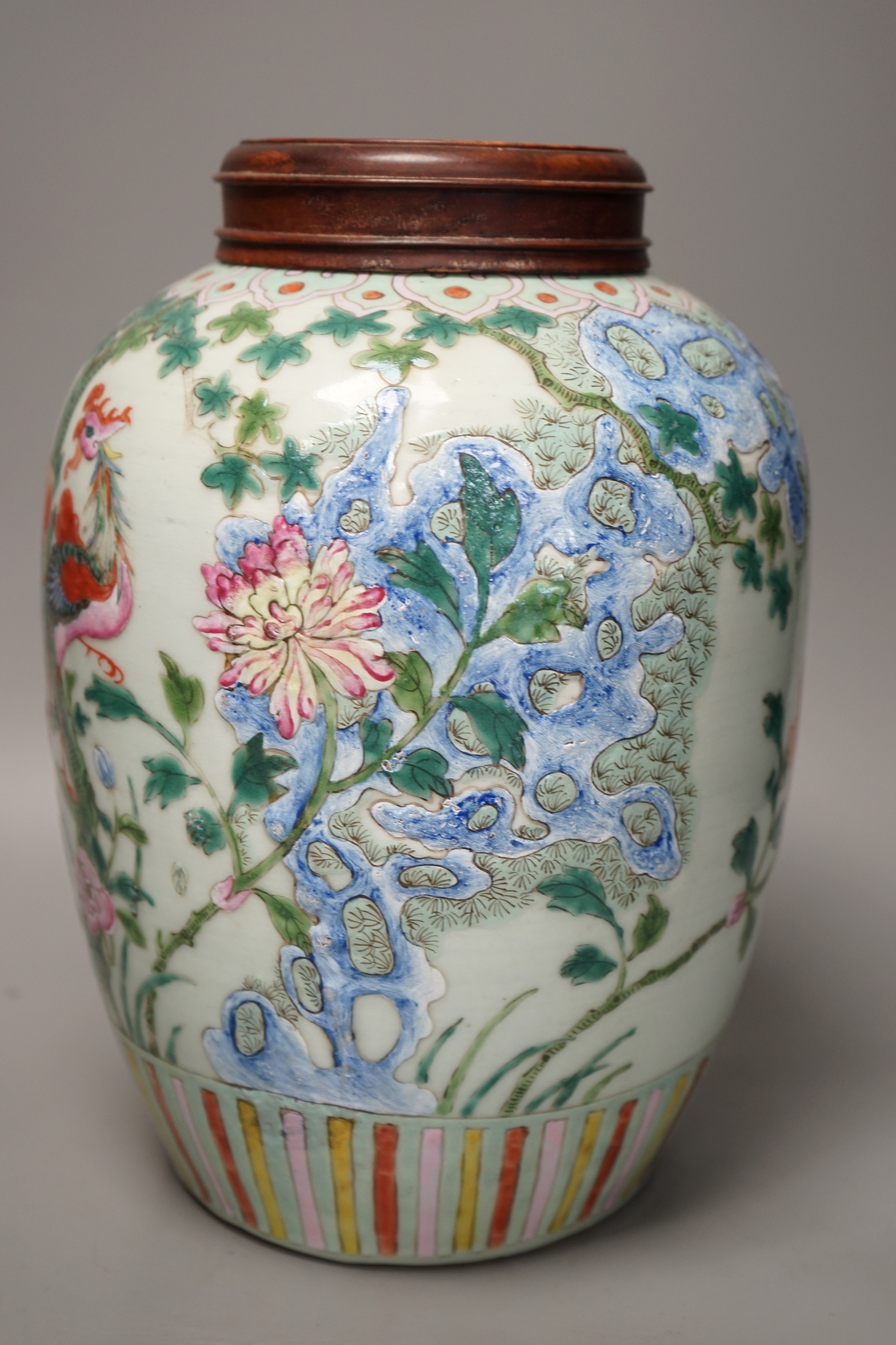 A 19th century Chinese famille rose 'phoenix' jar with wood cover, 30cm tall